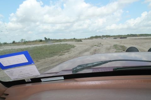 1990 Ford Bronco - Driving on a dirt road with other vehicles visible in the distance.