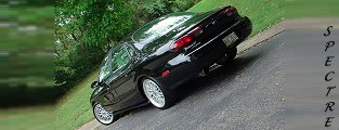 1999 Ford Taurus - A black 1999 Ford Taurus is shown from a three-quarter front angle on a paved road.