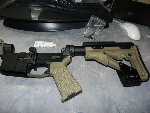 1996 Ford Bronco - Firearm lower receiver and stock assembly with KNS Gen 2 packaging on a desk.