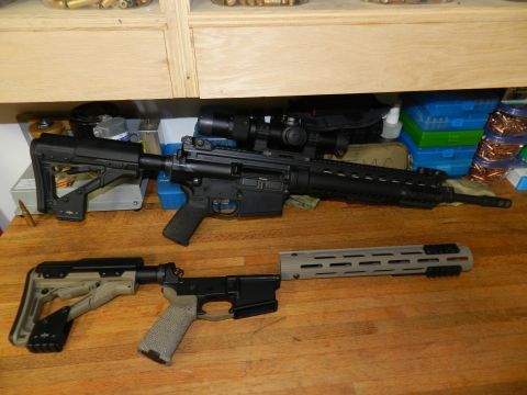 1996 Ford Bronco - Disassembled firearms, one with a scope, are laid out on a wooden table with ammunition boxes in the background.
