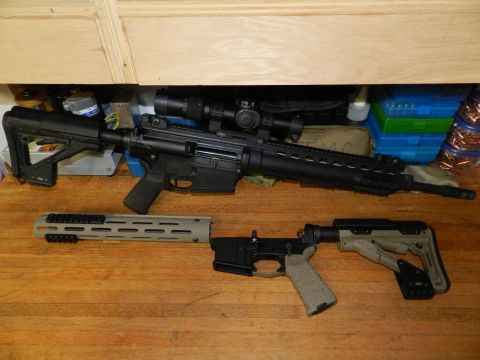 1996 Ford Bronco - Two disassembled firearms, including an AR-15 rifle with a scope and a separate lower receiver, are laid out on a wooden surface alongside…