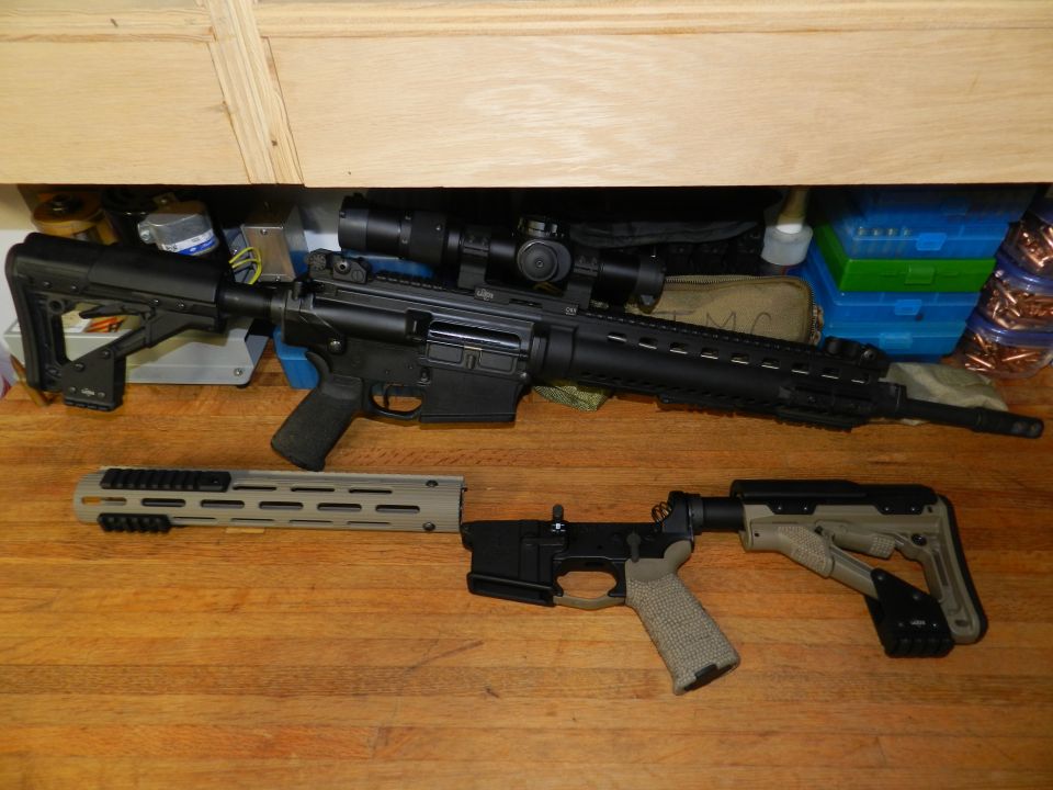 Disassembled AR-15 rifle with scope and separate lower receiver on wooden surface