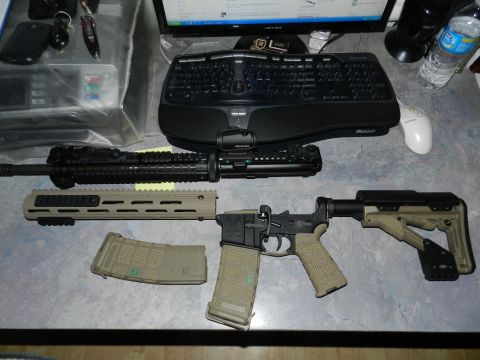 1996 Ford Bronco - An assault rifle is laid out with its components, including a magazine and a red dot sight.