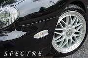 1999 Ford Taurus - Aftermarket wheels and custom paint on a car's front section, with 'SPECTRE' text.