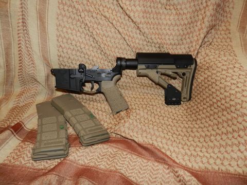 1996 Ford Bronco - AR-15 lower receiver assembly with adjustable stock and two magazines displayed on a patterned cloth.