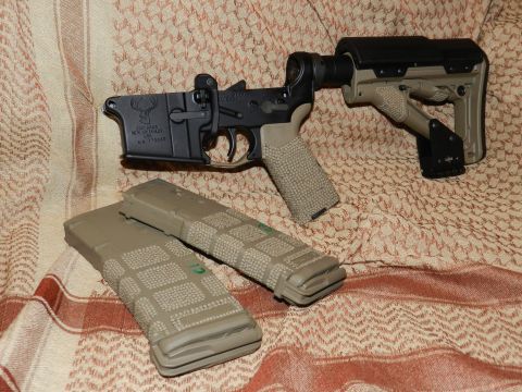 1996 Ford Bronco - AR-15 lower receiver and magazines are displayed on a patterned cloth background.