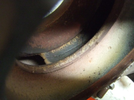 1996 Ford Bronco - This is a close-up view of a vehicle's exhaust manifold, showing signs of wear and discoloration.