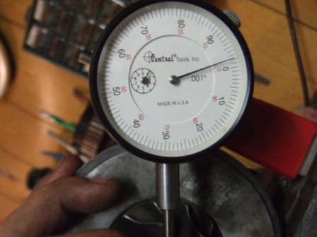 1996 Ford Bronco - A dial indicator is used to measure a component, with "001" indicating the precision.