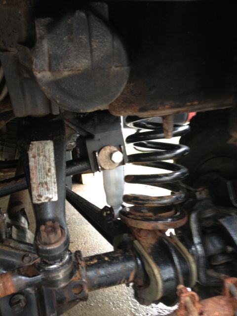 1996 Ford F-150 - Undercarriage view of a vehicle's suspension system with visible rust and wear.