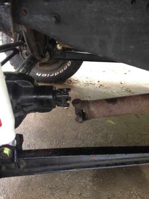 1996 Ford F-150 - Underside view of a vehicle's drivetrain components, showing the driveshaft and differential connection.