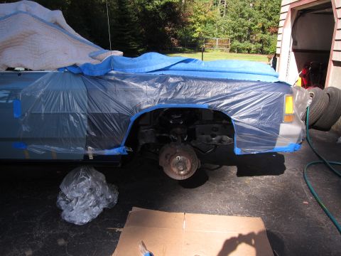 1991 Ford LTD Crown Victoria - Car undergoing front end repair, with fender and wheel well covered.