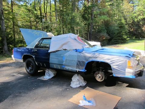 1991 Ford LTD Crown Victoria - 1991 Ford Crown Victoria LTD is prepped for bodywork, with parts of it covered in plastic sheeting.
