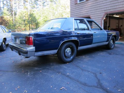 1991 Ford LTD Crown Victoria - This 1980s Ford LTD Crown Victoria features a two-tone paint job and is parked next to another vehicle.