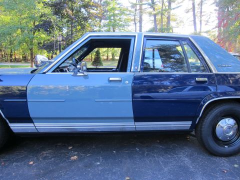 1991 Ford LTD Crown Victoria - This 1991 Ford Crown Victoria LTD features a distinctive two-tone blue paint scheme and chrome trim along the side.