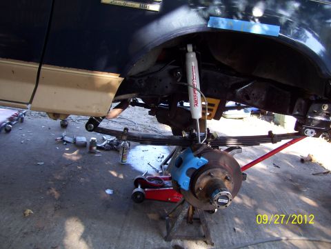 1990 Ford Bronco - The front suspension and brake assembly of a 1990 Ford Bronco Eddie Bauer trim is shown during a repair process.