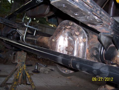 1990 Ford Bronco - Close-up view of the rear axle assembly and suspension components of a vehicle undergoing maintenance.