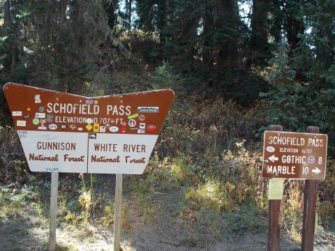 1986 Ford Bronco II - A signpost indicates the way to Schofield Pass, with directions to Gunnison and White River National Forests.