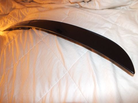 2003 Ford Crown Victoria - Underside reflection of a glossy black trunk lip spoiler on a comforter