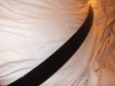 2003 Ford Crown Victoria - Thin black spoiler lip seen edge-on against a quilted comforter