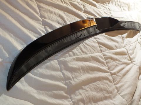 2003 Ford Crown Victoria - Mounting underside of a black decklid spoiler laid on a quilted comforter