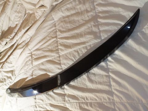 2003 Ford Crown Victoria - Glossy black decklid spoiler laid across rumpled bedding