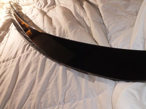 2003 Ford Crown Victoria - Low-angle detail of a black decklid spoiler reflecting light on a comforter