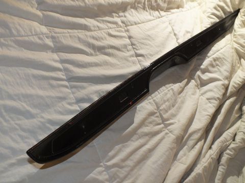 2003 Ford Crown Victoria - Narrow black trunk spoiler with mounting tabs laid diagonally on bedding