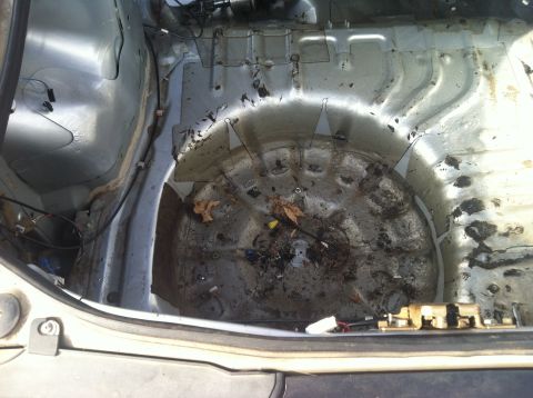 1993 Ford Probe - The interior of a vehicle's trunk is shown, appearing dirty and empty.