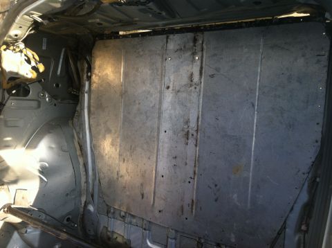 1993 Ford Probe - The interior of a vehicle has been stripped down to its bare metal frame and panels.