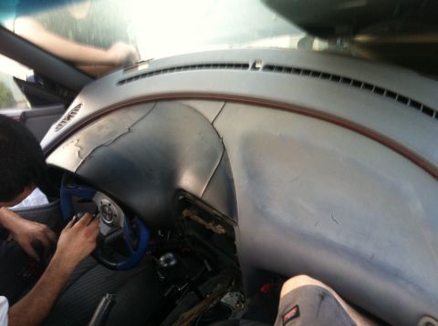 1993 Ford Probe - Interior view of a cracked dashboard and steering wheel, possibly undergoing repair.
