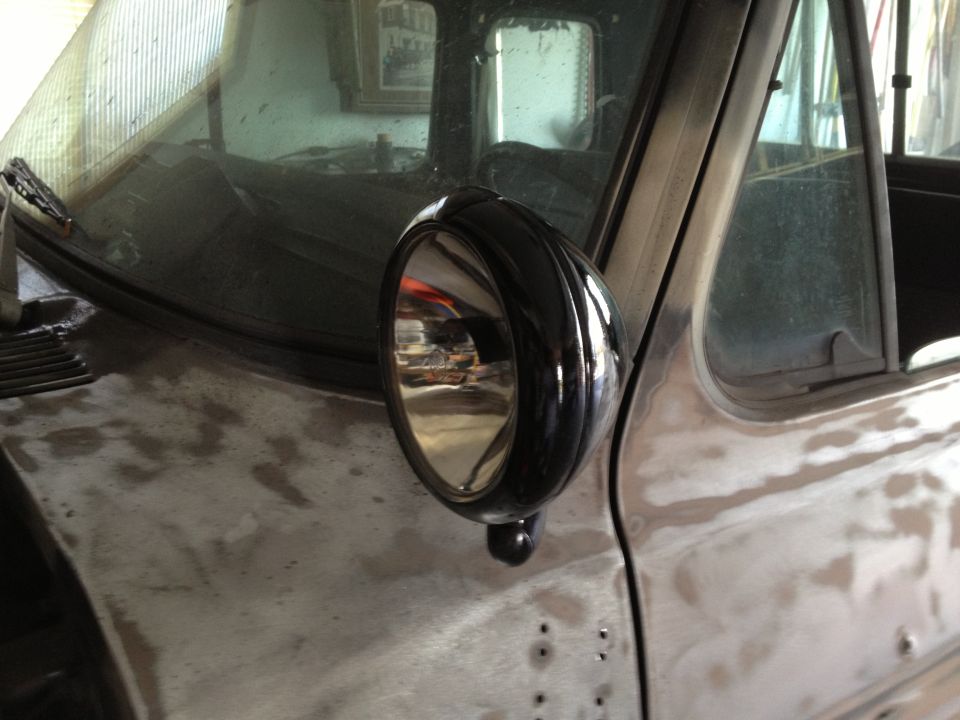 Black side mirror on a truck fender