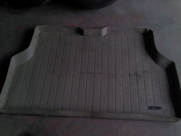 Tan WeatherTech floor mat with grid pattern