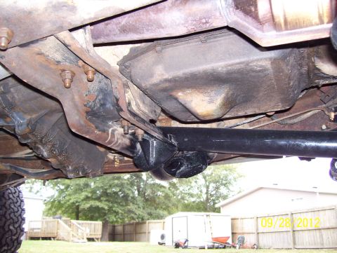 1990 Ford Bronco - A close-up view of the underside of a vehicle, showing the drivetrain and suspension parts.