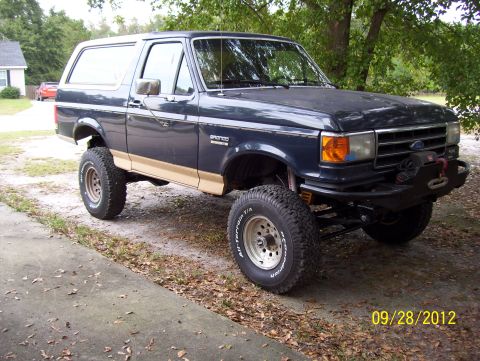 1990 Ford Bronco - This 1990 Ford Bronco features a lifted suspension and an aftermarket bumper with a winch.