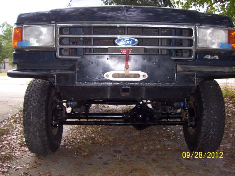 1990 Ford Bronco - This Ford truck features a custom bumper with a winch and 4x4 badging visible on the grille area.