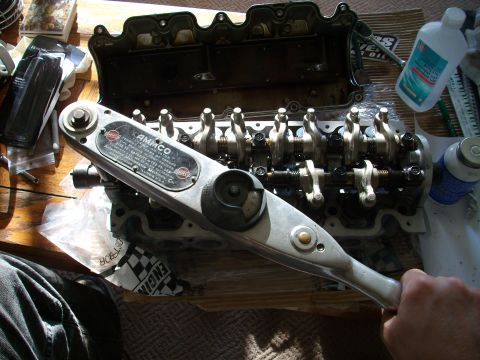 1989 Ford Probe - Close-up of an engine's valve train and an AMMCO torque wrench, suggesting mechanical work.