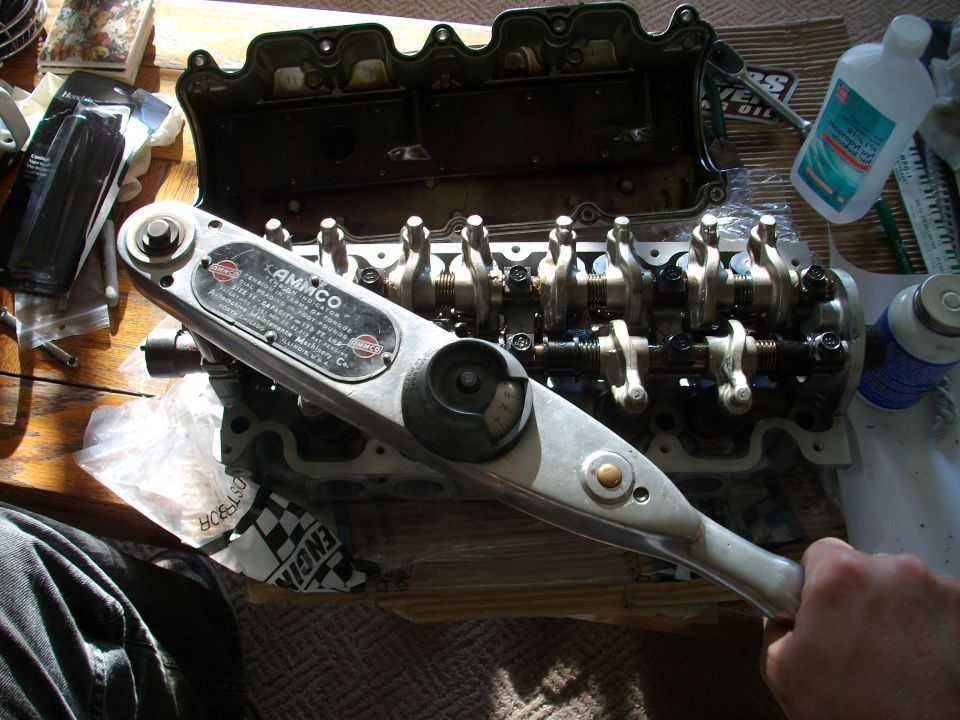Engine valve train with AMMCO torque wrench on a wooden surface
