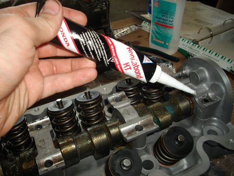 1989 Ford Probe - Applying liquid gasket sealant to an engine cylinder head during a repair or rebuild process.