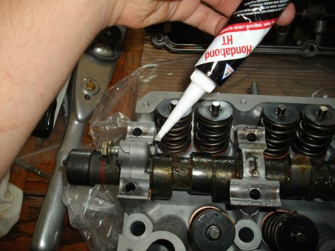 1989 Ford Probe - Applying gasket sealant to an engine cylinder head during a repair or rebuild process.
