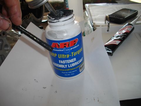 1989 Ford Probe - A bottle of ARP Ultra-Torque Fastener Assembly Lubricant is shown with a threaded rod being prepared for use.