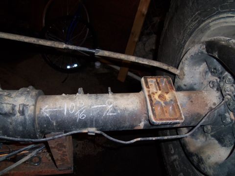 1989 Ford Bronco - Rear axle housing with chalk measurements '10 3/16' and '-9/2' written on it.
