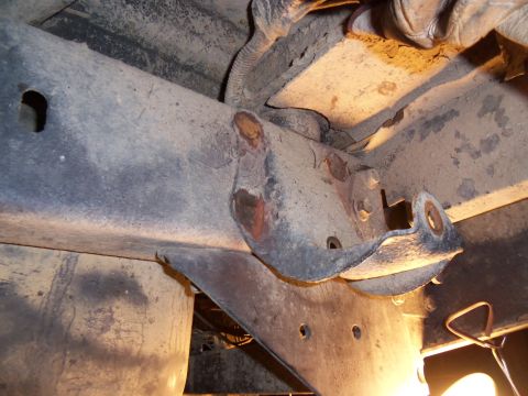 1989 Ford Bronco - Underside view of a vehicle's frame and suspension components, showing rust and wear.