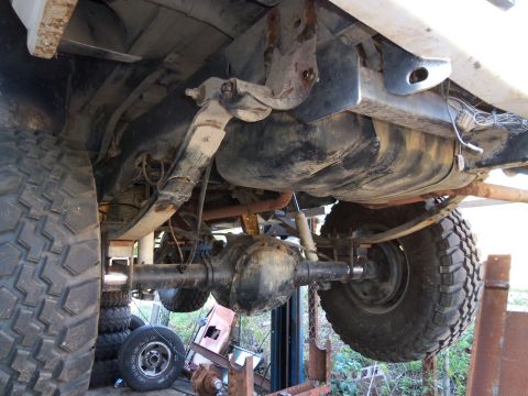 1989 Ford Bronco - Underside view of a vehicle's rear suspension system, including the fuel tank and differential.