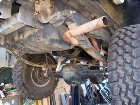 1989 Ford Bronco - Vehicle rear axle and suspension components are visible, including leaf springs and exhaust.