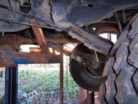 1989 Ford Bronco - Close-up view of the rear suspension system, showing leaf springs and a shock absorber.
