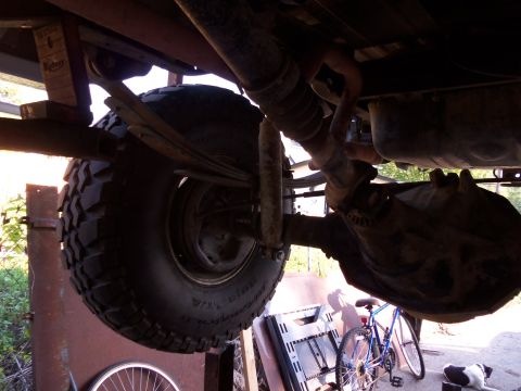 1989 Ford Bronco - Close-up of rear axle and suspension components, showing leaf springs and a shock absorber.