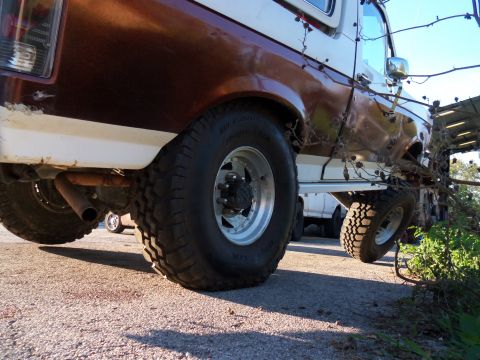 1989 Ford Bronco - Close-up view of the rear wheel and suspension system of a vintage Ford Bronco.