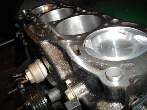1989 Ford Probe - Close-up view of an engine block's cylinders and attached components.
