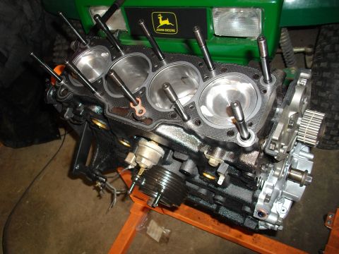 1989 Ford Probe - Engine block on a stand with a John Deere tractor visible behind it.