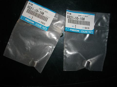 1989 Ford Probe - Close-up of two Mazda genuine parts packages, each containing a single pin and labeled with part number 0221-10-108.